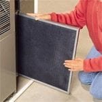 renter changing the air filter in rental property
