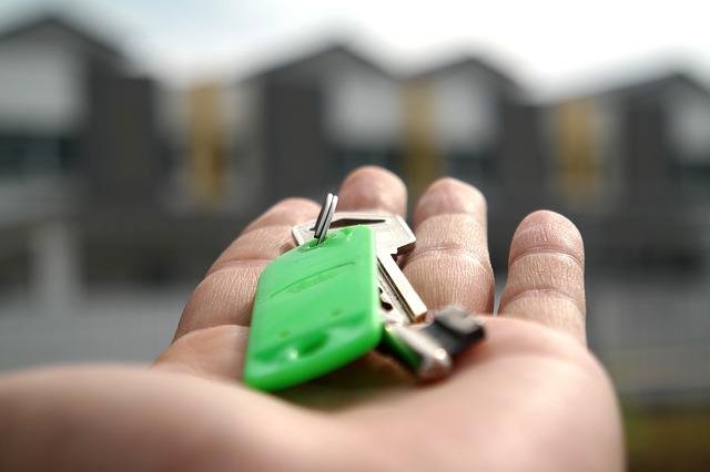 property manager holding keys to rental property